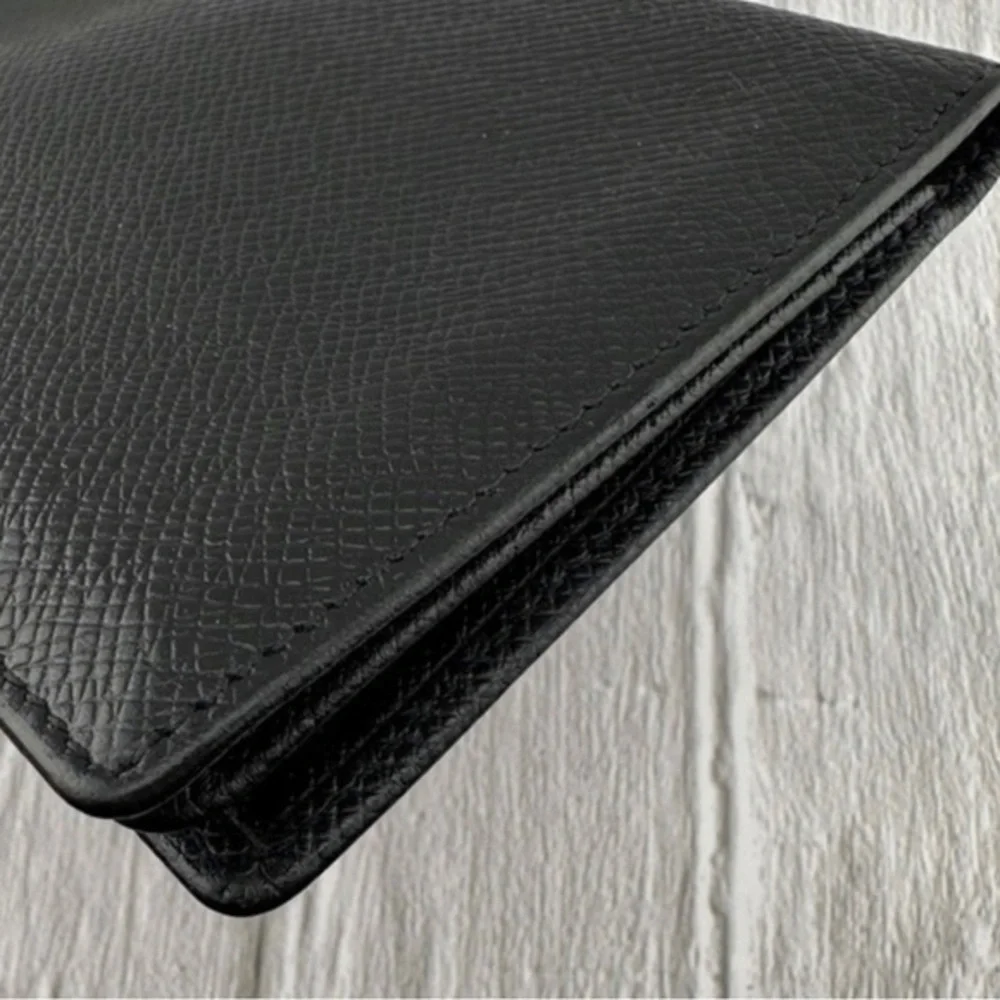 AUTHENTIC Louis Vuitton Taiga wallet. Previously owned. Color: Black.
